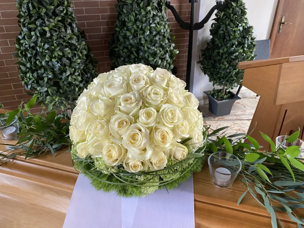 Sargschmuck aus weißen Rosen als Rosenkugel